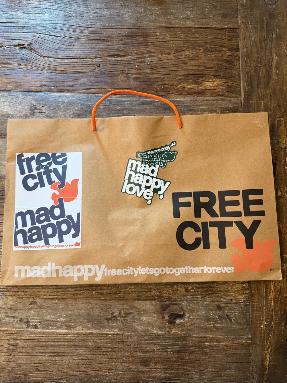 Madhappy Brown Paper Shopping Bag with Orange Handle and Black Logo